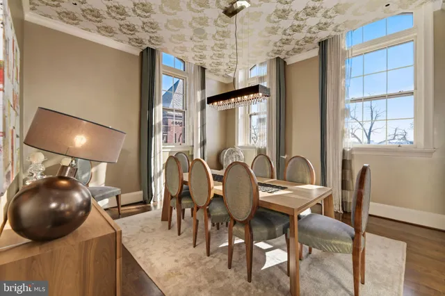 a view of a dining room with furniture and chandelier