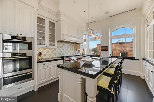 a kitchen with a stove a sink and a microwave