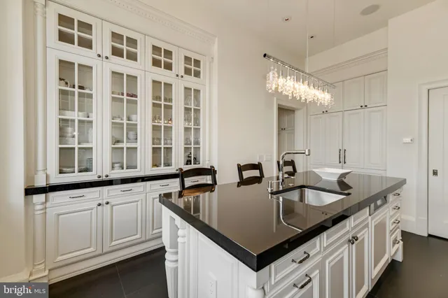 a kitchen with granite countertop a sink and cabinets