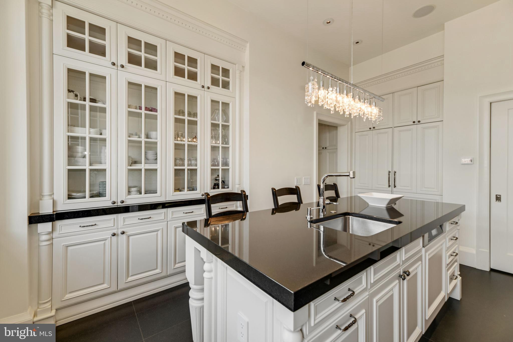 3329 Prospect Street Northwest, Unit 7 Washington, DC 20007 - Photo 13 of 50 a kitchen with granite countertop a sink and cabinets