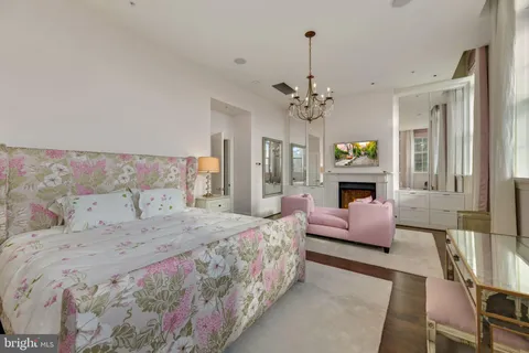 a bedroom with a bed wooden floor and a fireplace