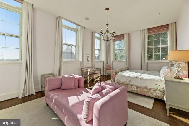 a bedroom with two beds and a chandelier