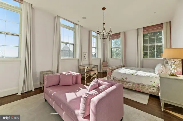 a bedroom with two beds and a chandelier