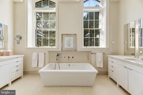 a bathroom with sink window and mirror