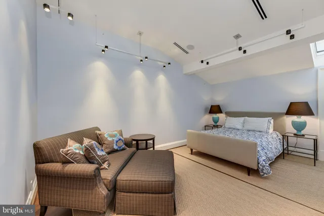 a bedroom with bed and a couch