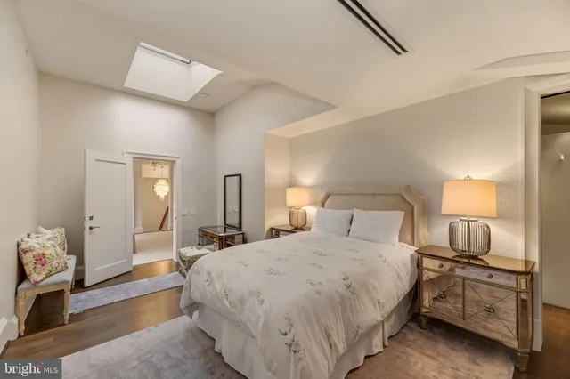 a large bedroom with a bed and wooden floor