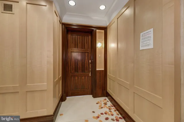 a view of hallway with wooden floor