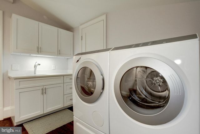 a utility room with sink dryer and washer