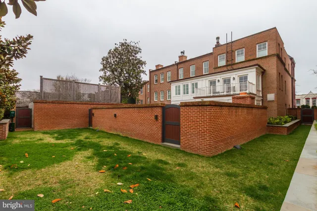 a front view of a building with a yard