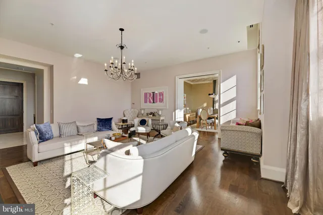 a living room with fireplace furniture and a chandelier