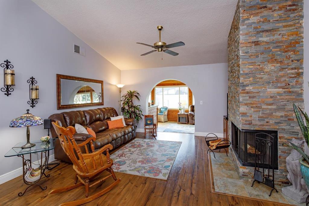 9237 Sabal Palm Circle Windermere, FL 34786 - Photo 12 of 44 a living room with furniture and a fireplace