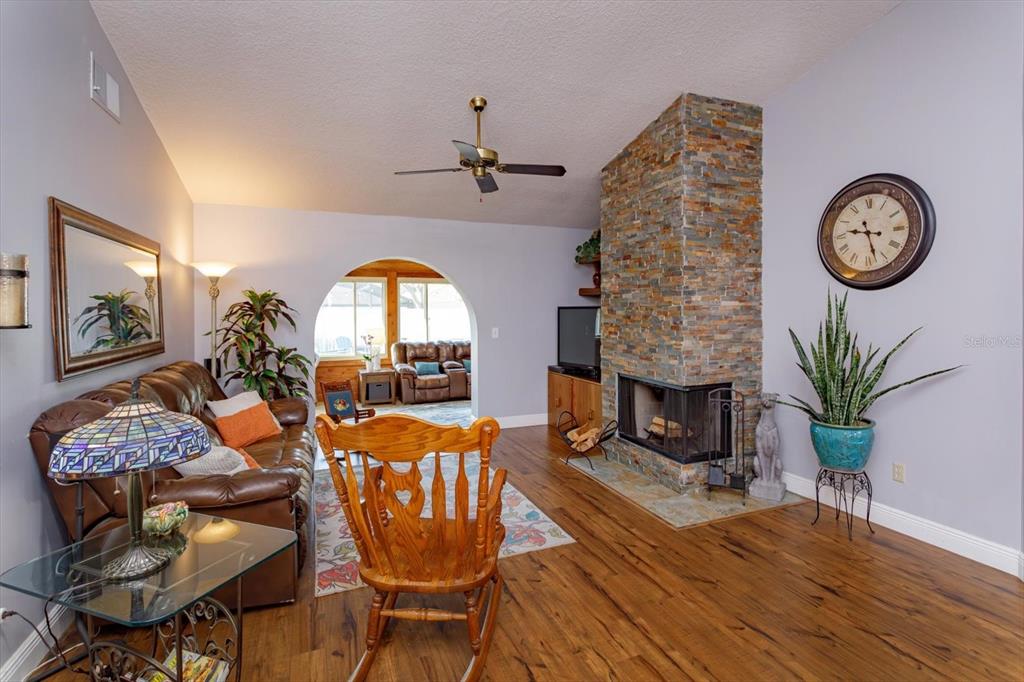 9237 Sabal Palm Circle Windermere, FL 34786 - Photo 13 of 44 a living room with fireplace furniture and wooden floor
