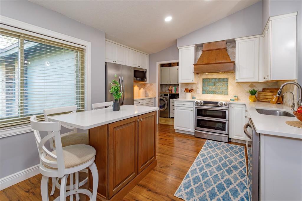 9237 Sabal Palm Circle Windermere, FL 34786 - Photo 15 of 44 a kitchen with a stove a sink and a refrigerator