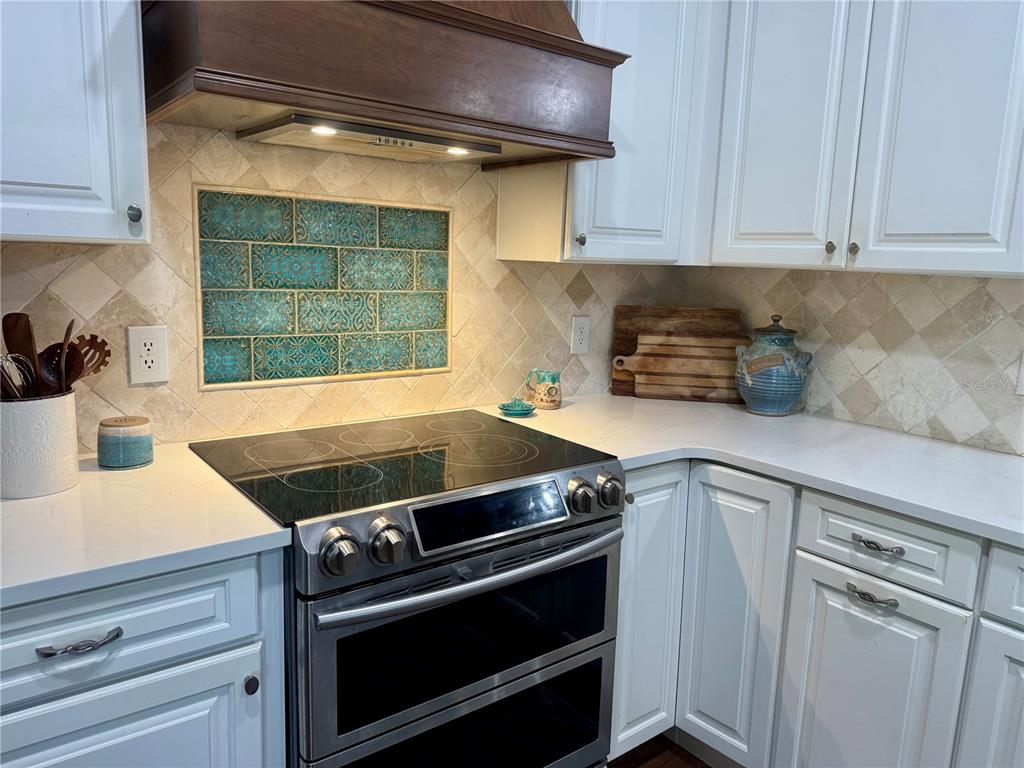 9237 Sabal Palm Circle Windermere, FL 34786 - Photo 16 of 44 a kitchen with a stove and white cabinets