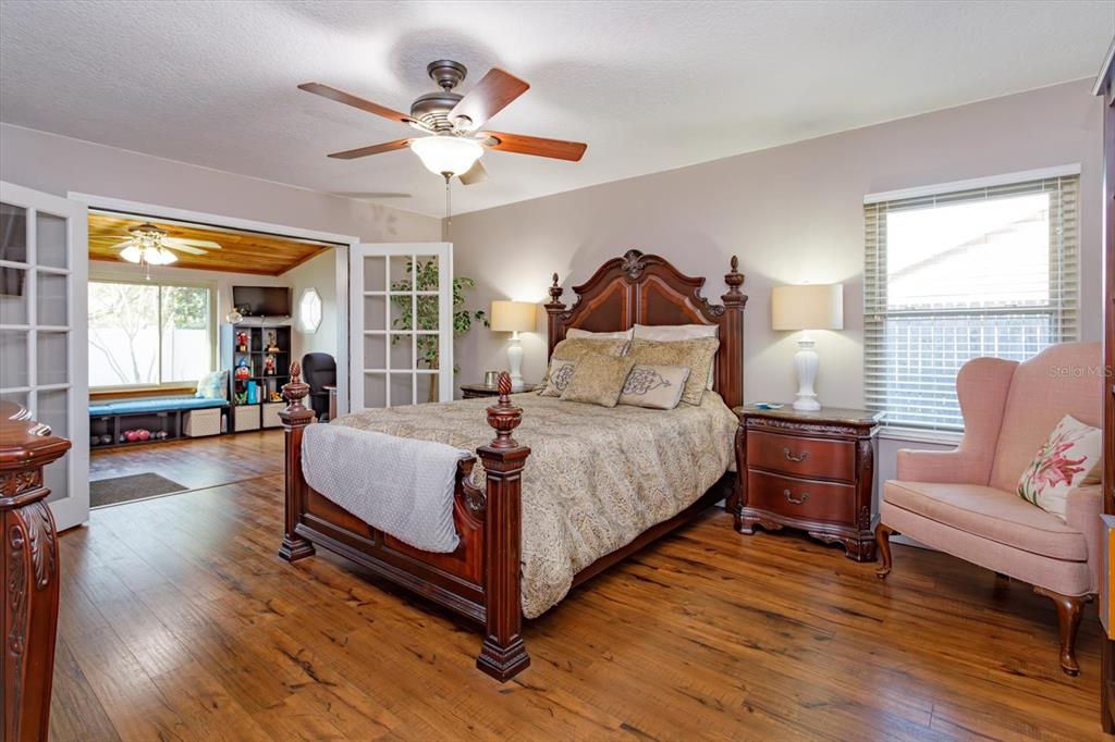 9237 Sabal Palm Circle Windermere, FL 34786 - Photo 19 of 44 a bedroom with a bed and wooden floor