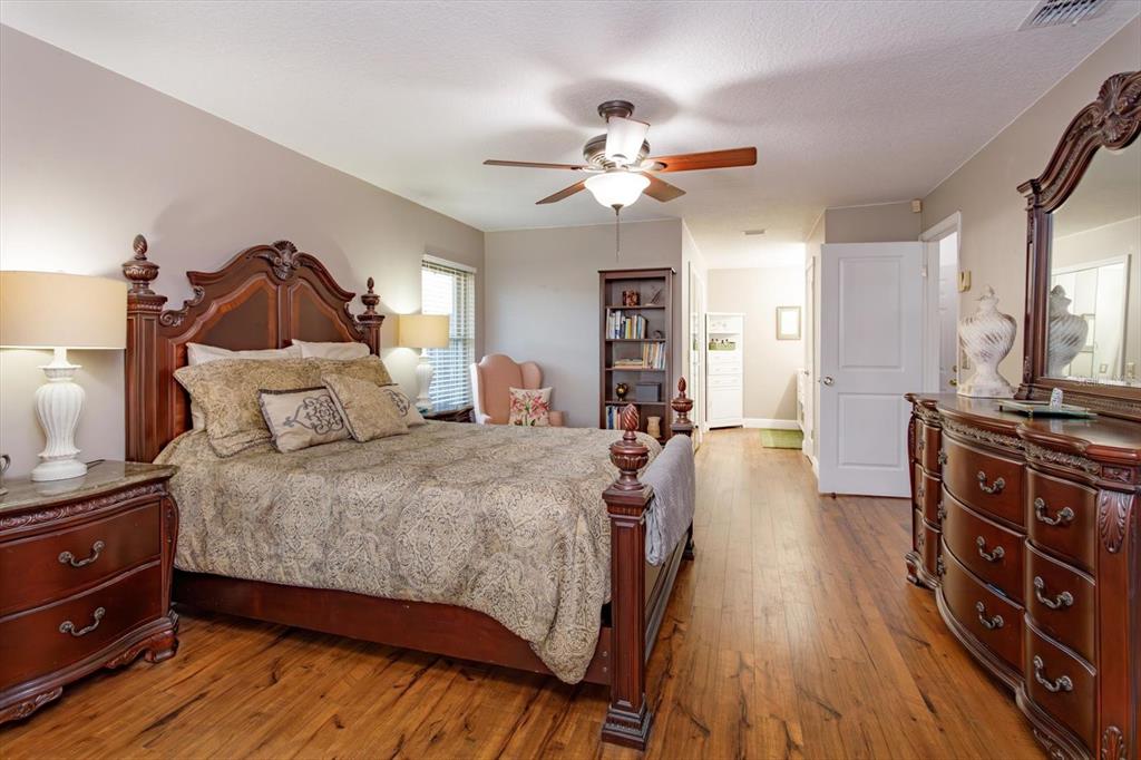 9237 Sabal Palm Circle Windermere, FL 34786 - Photo 20 of 44 a spacious bedroom with a bed and a chandelier