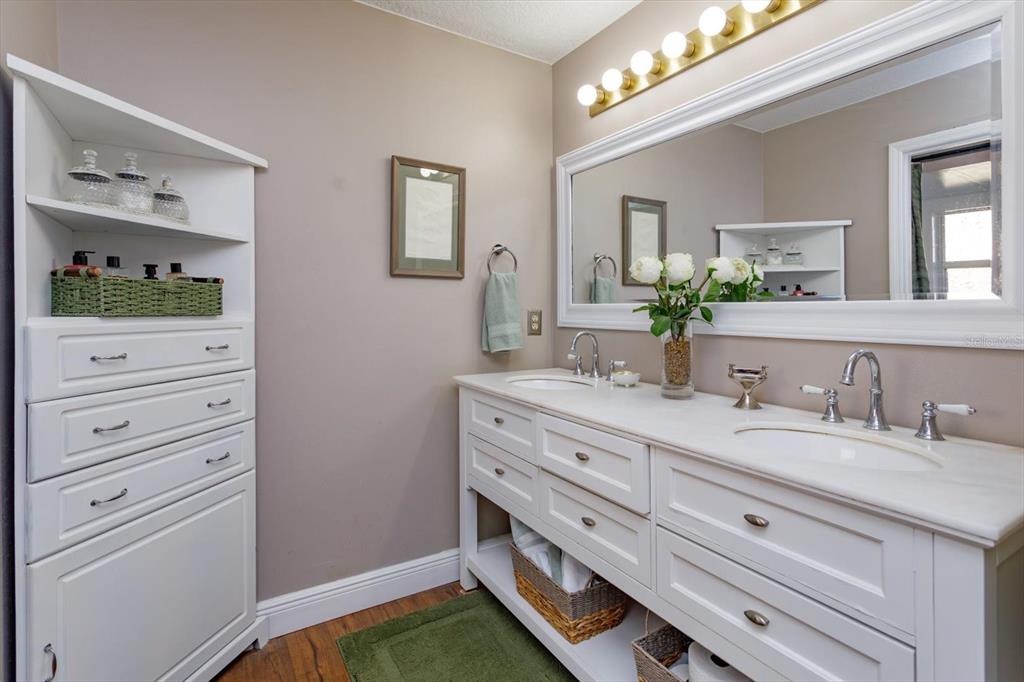 9237 Sabal Palm Circle Windermere, FL 34786 - Photo 22 of 44 a bathroom with a double vanity sink and a mirror