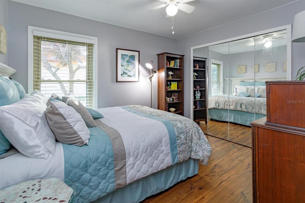 9237 Sabal Palm Circle Windermere, FL 34786 - Photo 27 of 44 a bedroom with a large bed and a chandelier