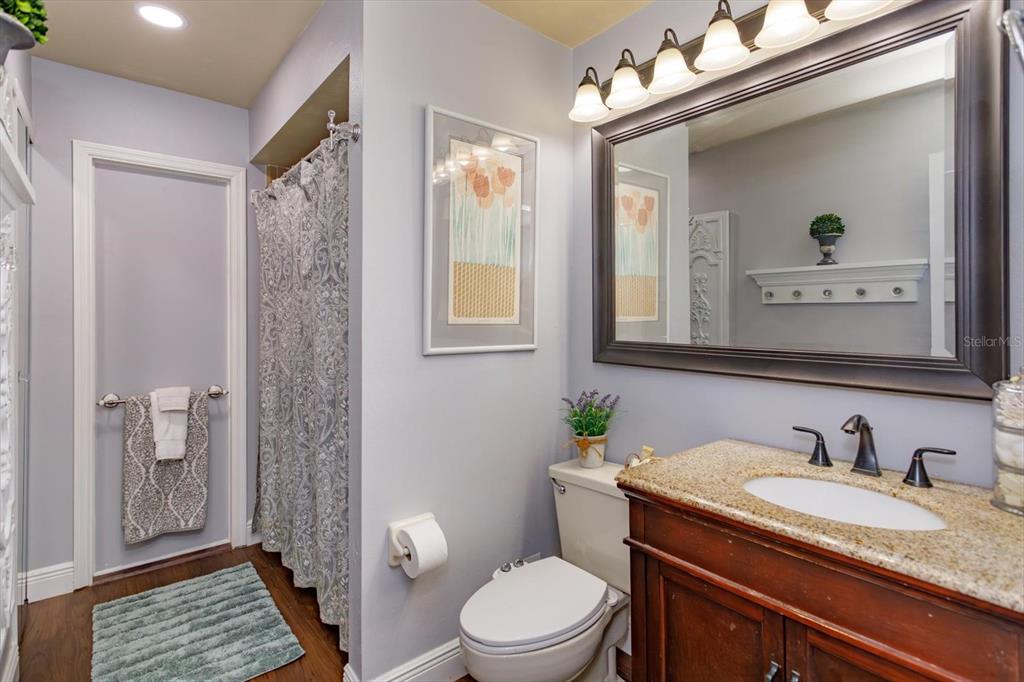 9237 Sabal Palm Circle Windermere, FL 34786 - Photo 28 of 44 a bathroom with a granite countertop sink toilet a mirror and shower