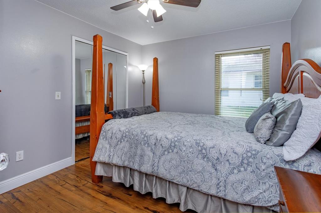 9237 Sabal Palm Circle Windermere, FL 34786 - Photo 29 of 44 a bedroom with a bed and a chandelier