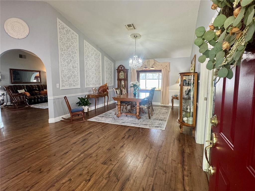 9237 Sabal Palm Circle Windermere, FL 34786 - Photo 3 of 44 a living room with furniture and a wooden floor