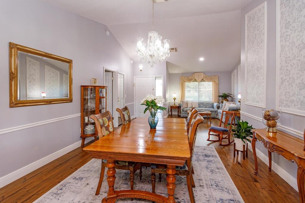 9237 Sabal Palm Circle Windermere, FL 34786 - Photo 5 of 44 a view of a dining room with furniture and wooden floor