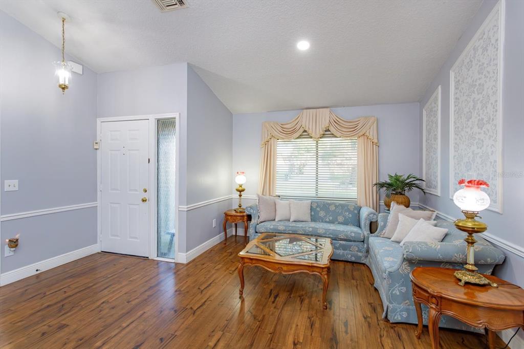 9237 Sabal Palm Circle Windermere, FL 34786 - Photo 6 of 44 a living room with furniture and a wooden floor