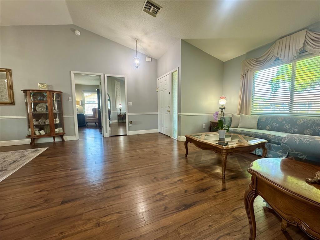 9237 Sabal Palm Circle Windermere, FL 34786 - Photo 10 of 44 a living room with furniture a table and wooden floor