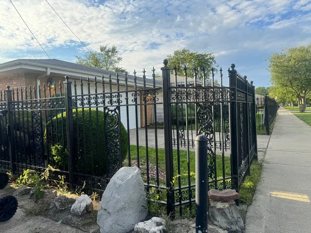 a view of a backyard house with large trees and plants