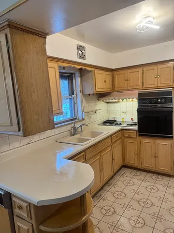 a kitchen with a sink appliances and cabinets