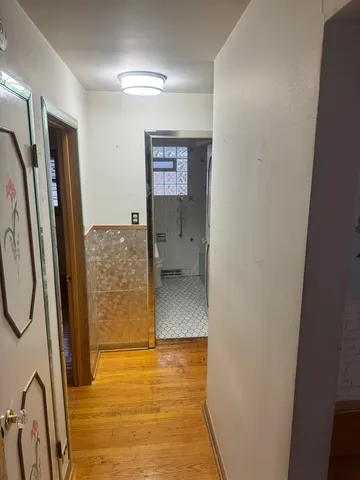 a view of a room with wooden floor and walls