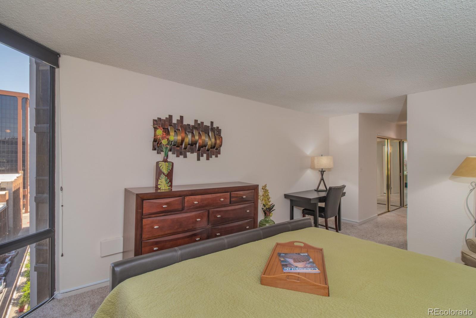 1625 Larimer Street, Unit 801 Denver, CO 80202 - Photo 11 of 33 a bed room with a bed and a dresser