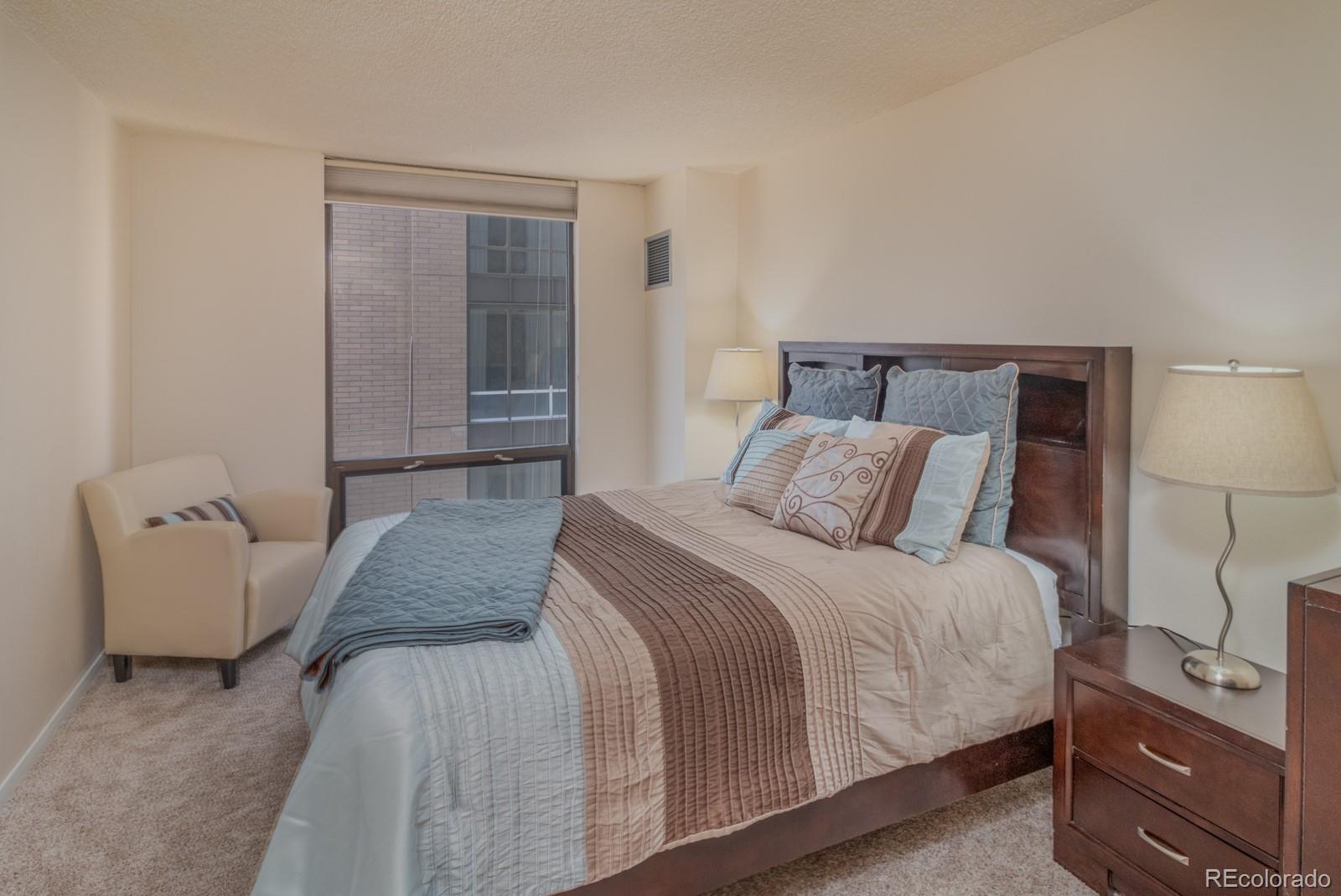 1625 Larimer Street, Unit 801 Denver, CO 80202 - Photo 14 of 33 a bedroom with a bed and a couch