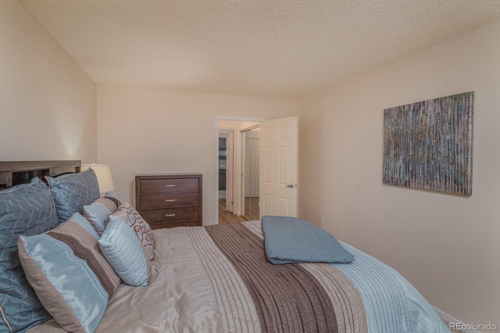 1625 Larimer Street, Unit 801 Denver, CO 80202 - Photo 15 of 33 a bedroom with a bed and a couch