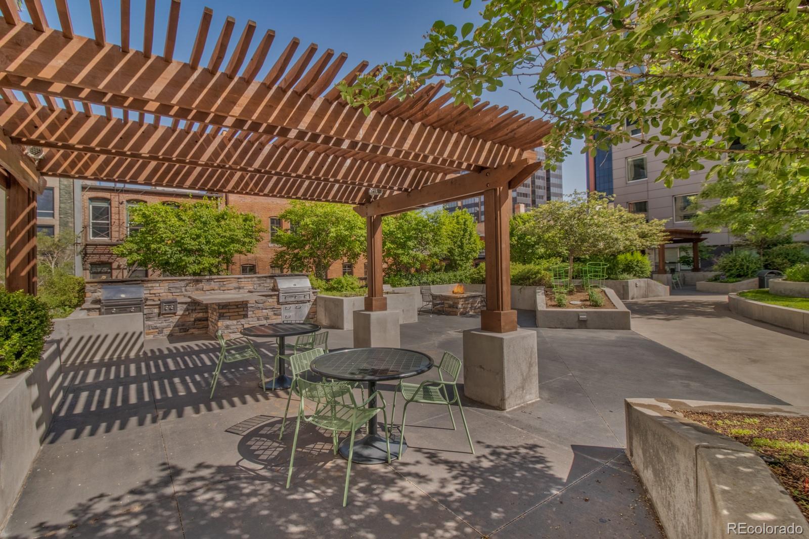 1625 Larimer Street, Unit 801 Denver, CO 80202 - Photo 19 of 33 a view of a patio with a table and chairs under a large umbrella