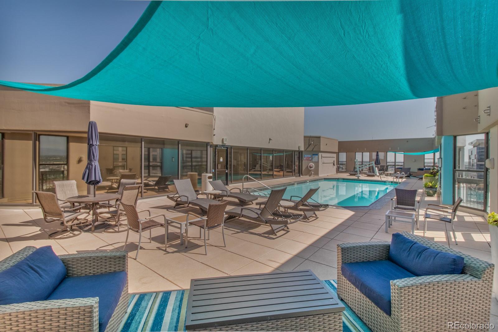 1625 Larimer Street, Unit 801 Denver, CO 80202 - Photo 27 of 33 a view of a patio with couches table and chairs and potted plants