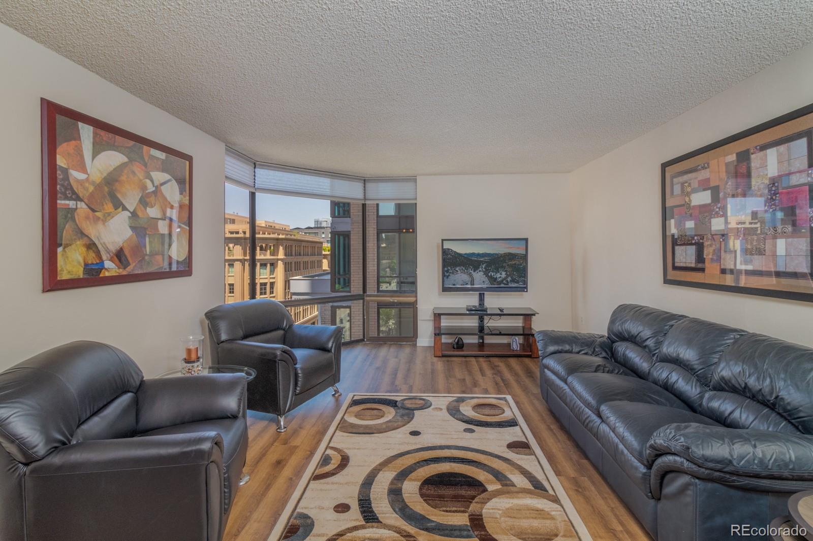 1625 Larimer Street, Unit 801 Denver, CO 80202 - Photo 3 of 33 a living room with furniture and a large window