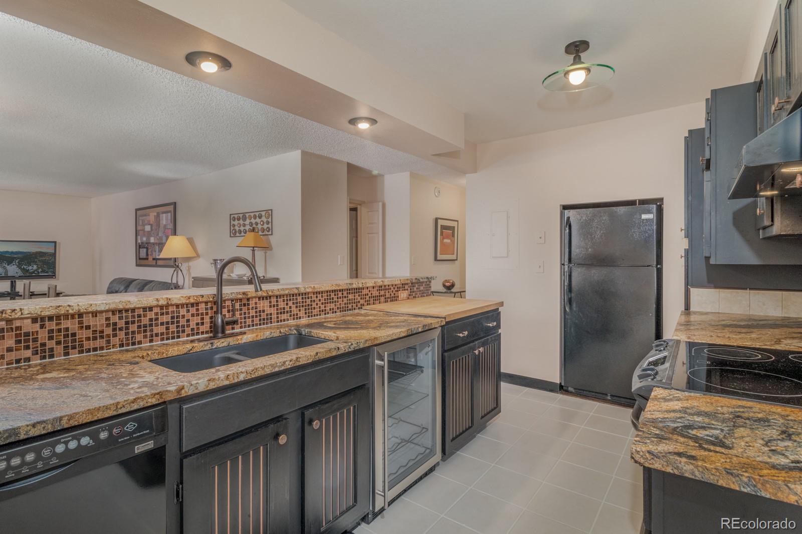 1625 Larimer Street, Unit 801 Denver, CO 80202 - Photo 6 of 33 a kitchen with a sink stove and refrigerator