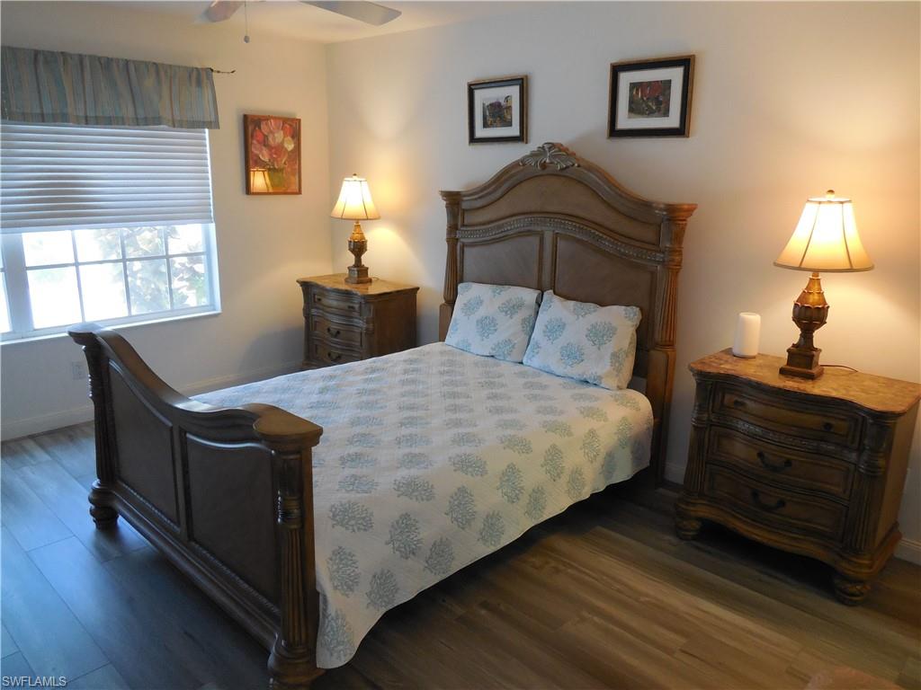 4663 Ossabaw Way Naples, FL 34119 - Photo 12 of 44 Bedroom with baseboards and wood finished floors