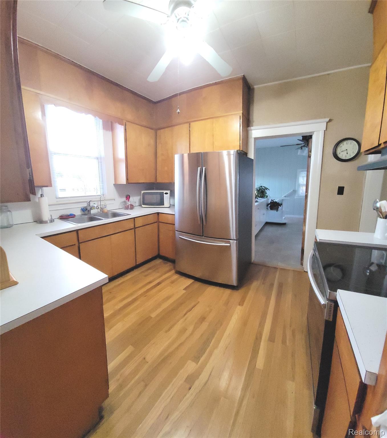 Kitchen featuring  stainless steel appliances and hardwood floors 