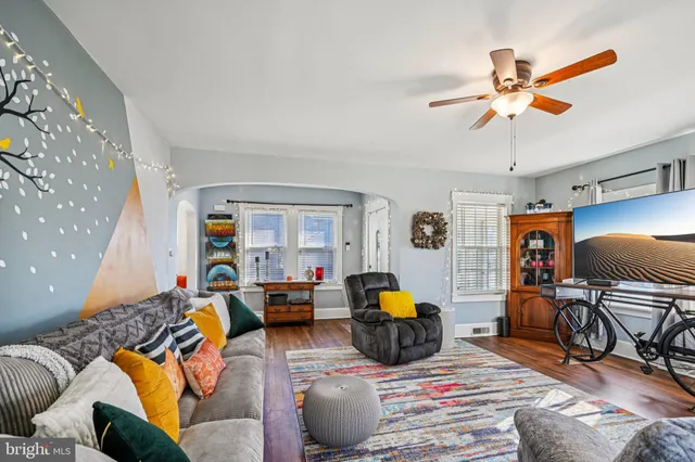 a living room with furniture fireplace and a window