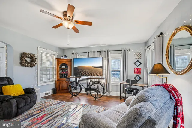a living room with furniture and a mirror