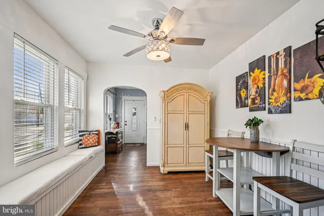 a living room with fireplace furniture and a large window