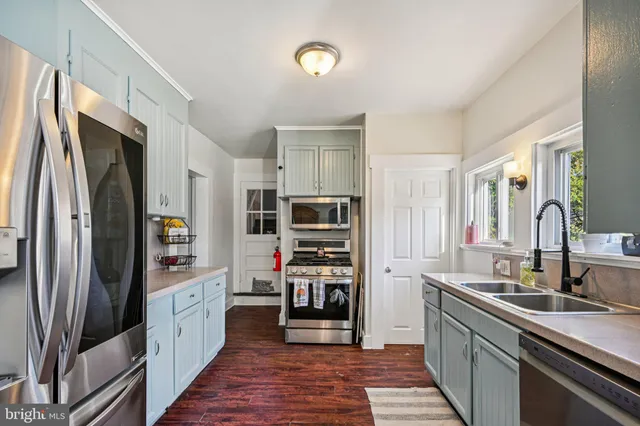 a kitchen with stainless steel appliances a refrigerator and a sink