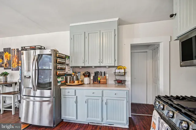 a kitchen with stainless steel appliances a refrigerator and a stove top oven