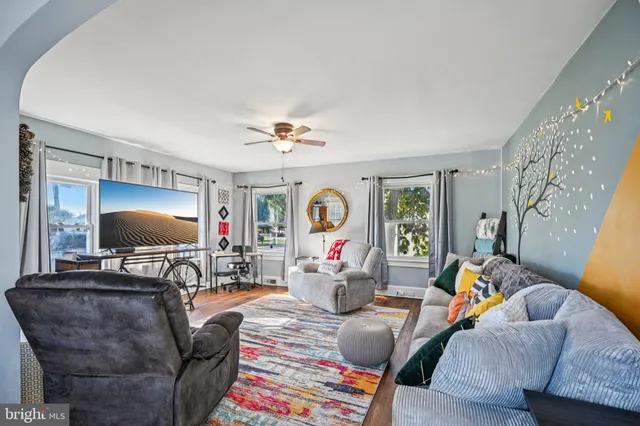 a living room with furniture and a flat screen tv