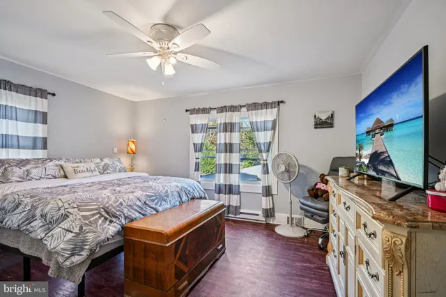 a bed room with a bed and a flat tv screen