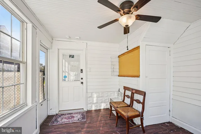 a view of a livingroom with a chair and wooden floor