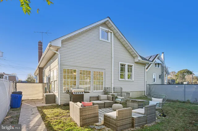 a view of a house with couches chairs and wooden floor