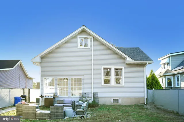 a view of backyard with table and chairs and potted plants